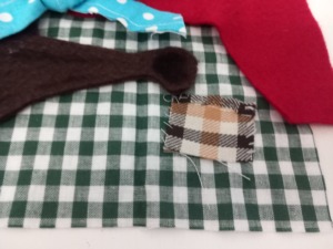 O Bolso
Pormenor do tecido que representa o Caçador/Lenhador